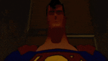 a close up of a man in a superman costume laying down in a dark room .