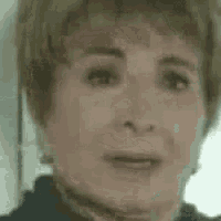 a close up of a woman 's face with a blurry background and a blurred background .