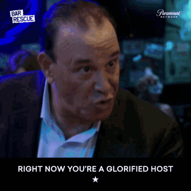 a man in a suit says " right now you 're a glorified host " in front of a paramount network logo