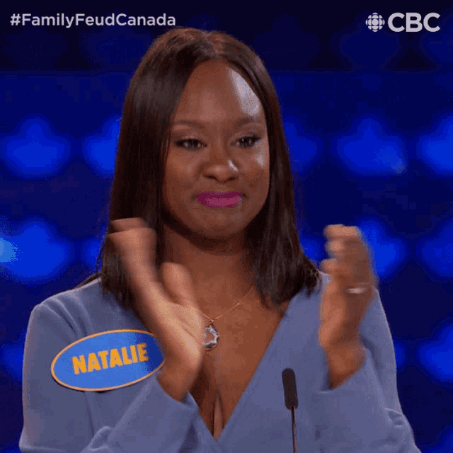 a woman wearing a blue shirt with natalie written on it