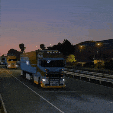 a volvo truck is driving on a highway at night