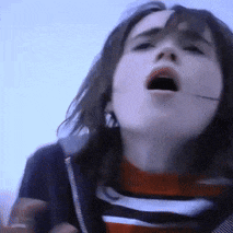 a close up of a girl with her mouth open