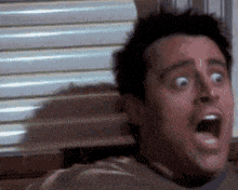 a close up of a man 's face with his mouth wide open
