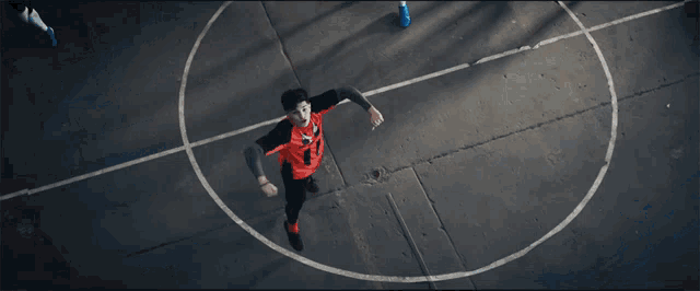 a man in an orange jersey with the number 11 on it is running on a basketball court
