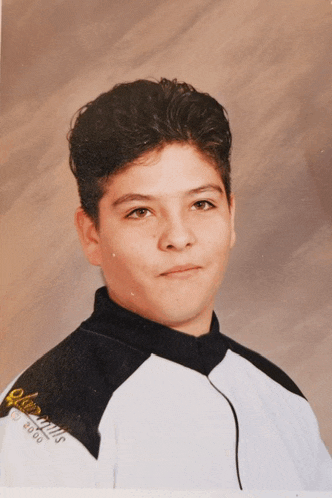 a young man is wearing a black and white jacket with the year 2000 on the back