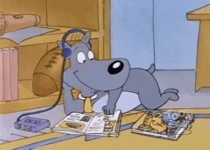 a dog wearing headphones is reading a book