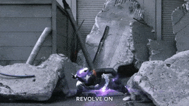a person is standing in front of a pile of rocks with the words " revolve on " above them
