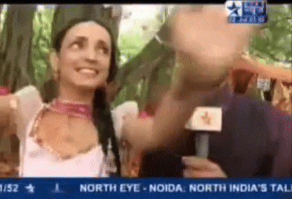 a woman is talking into a microphone on a tv screen that says north eye noida north india 's tall