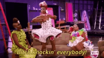 three drag queens are sitting on a couch and one of them is saying bitch knockin ' everybody .