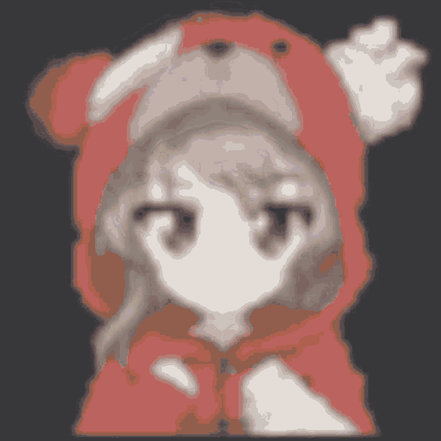 a girl wearing a red hoodie and a teddy bear hat is pointing at the camera .