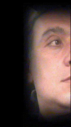 a close up of a man 's face with his eyes closed