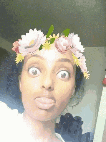 a woman is wearing a flower crown on her head