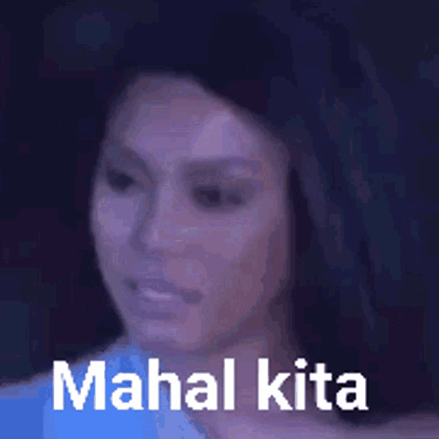 a close up of a woman 's face with the words mahal kita written above her .