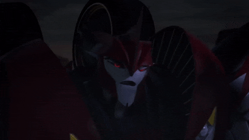 a close up of a red robot in the dark .