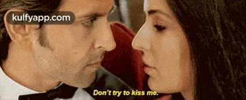 a man and a woman are kissing and the woman is saying do n't try to kiss me