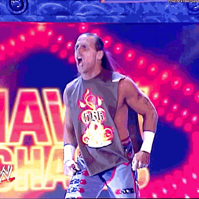 a wrestler wearing a tank top that says 666 on it