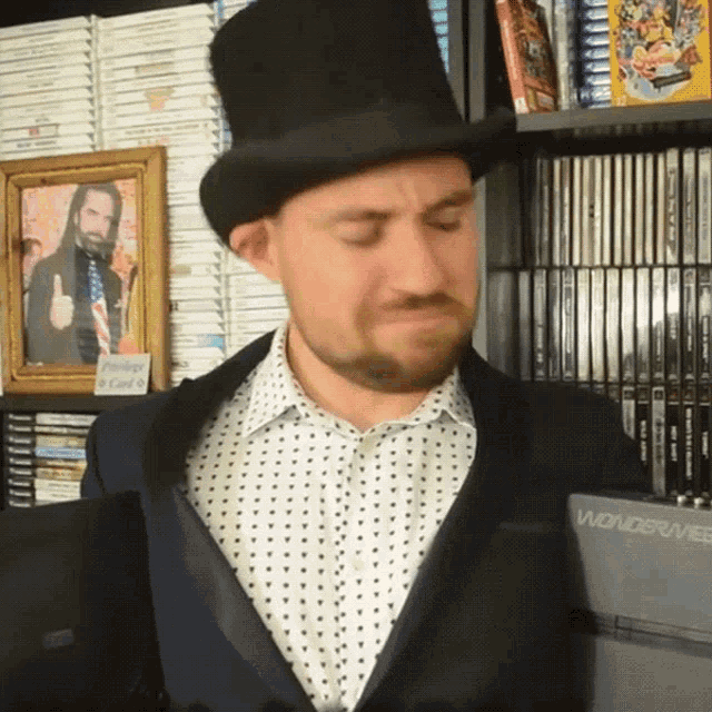 a man wearing a top hat is standing in front of a wondershare dvd player