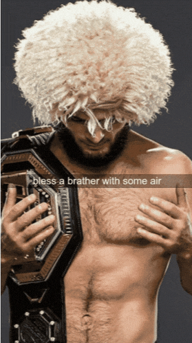 a man with a wig and a belt that says " bless a brother with some air " on it