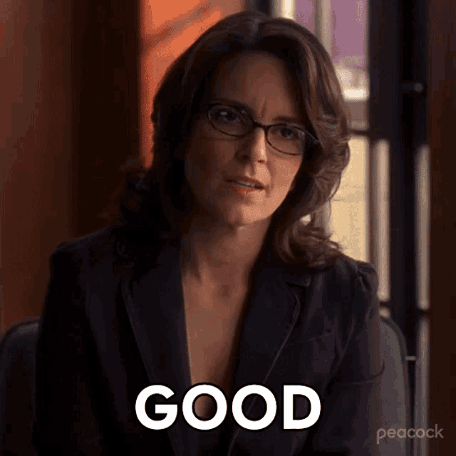a woman wearing glasses is sitting in a chair with the word good in front of her
