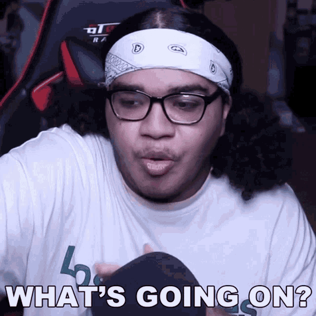 a man wearing glasses and a headband says what 's going on