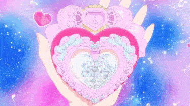 a person is holding a pink heart shaped object with a diamond inside