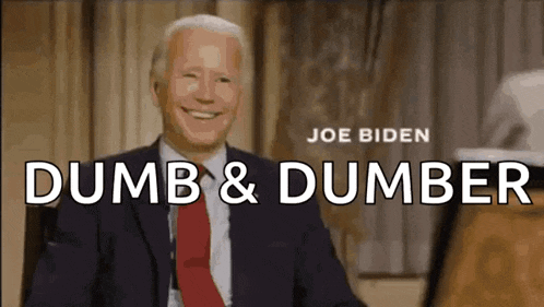 a man in a suit and tie is smiling with the words dumb & dumber behind him