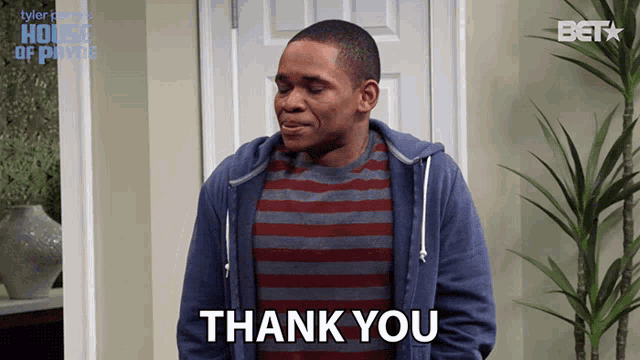 a man wearing a striped shirt says thank you