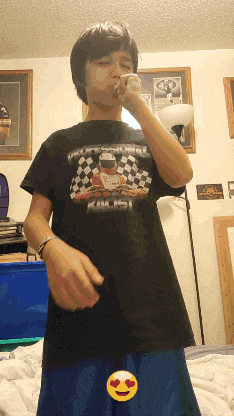 a young boy wearing a black shirt that says karting