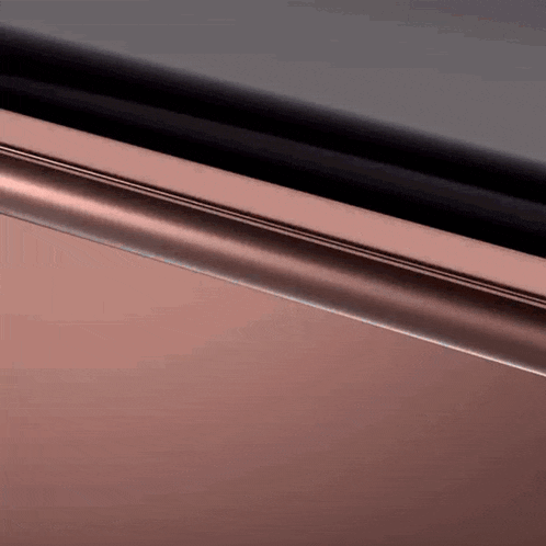 a close up of a metal surface with a black border