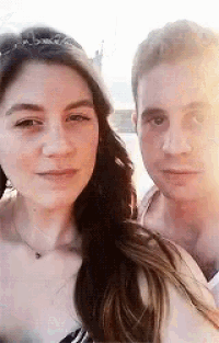 a man and a woman are posing for a picture together .