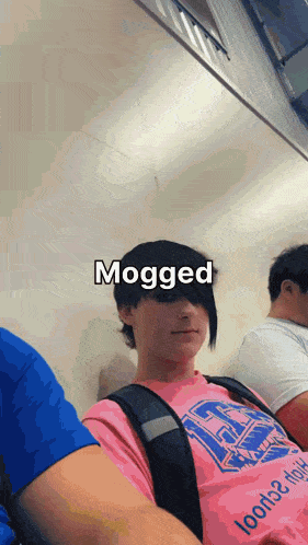 a girl in a pink shirt with the word mogged written on it