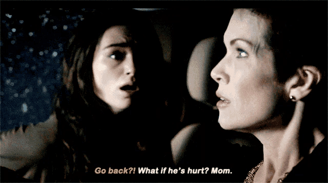 two women in a car with one saying go back