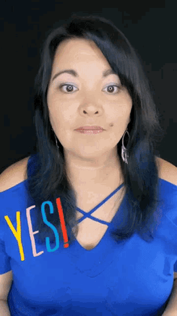 a woman wearing a blue shirt that says yes on it