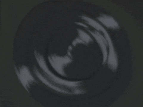 a black object is against a blue sky with clouds