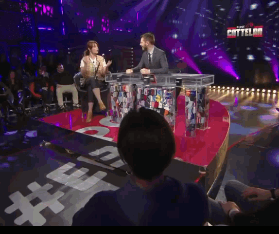 a man and woman are sitting at a table in front of a screen that says " cattlelord "