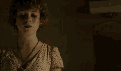 pennywise the clown is standing next to a woman in a dark room .