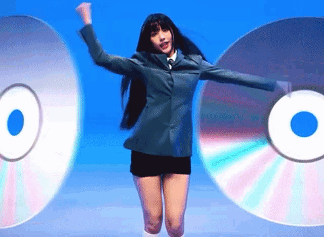 a woman in a suit is jumping in the air