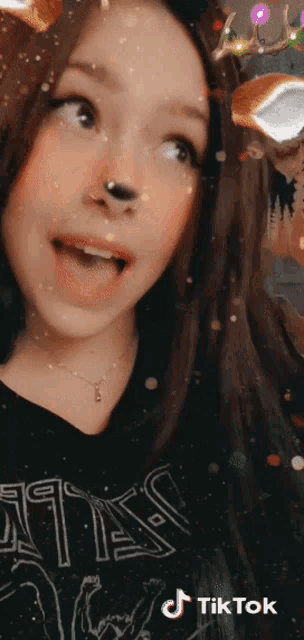 a woman wearing a black shirt that says ' witch ' on it