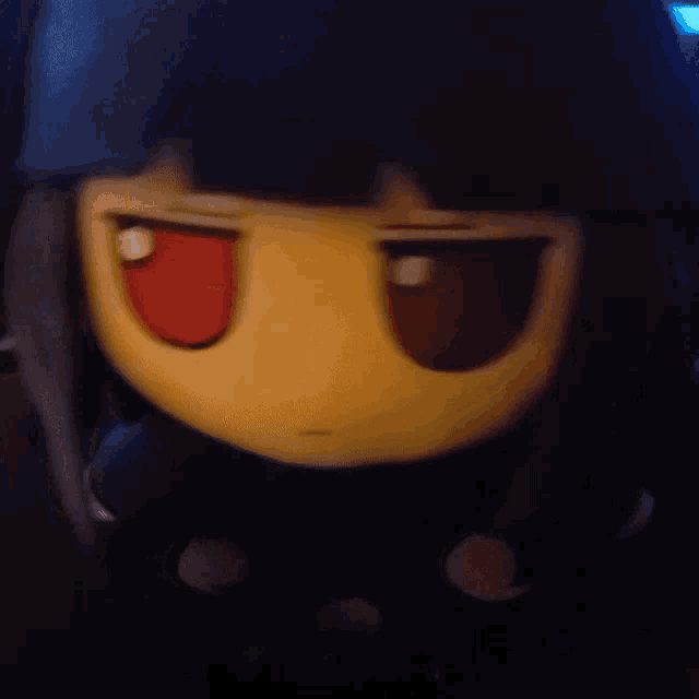 a close up of a doll with red eyes