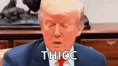 donald trump is wearing a suit and tie and making a funny face while sitting at a desk with his eyes closed .