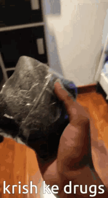 a person is holding a bag that says ' krish ke drugs ' on the bottom