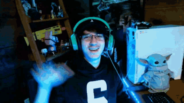 a man wearing headphones and a shirt that says c on it