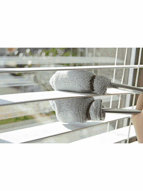 a balcony with a glass railing and a tiled floor that says ' t ' on it