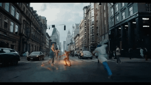 a blurry picture of a city street with a few people running