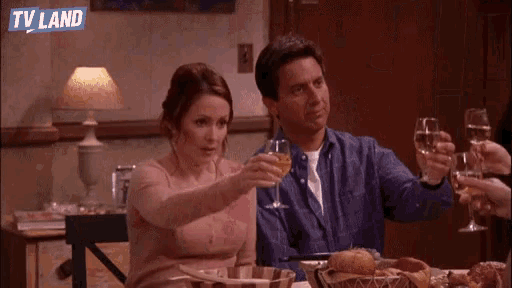 a group of people are toasting with wine glasses with a tv land logo in the background