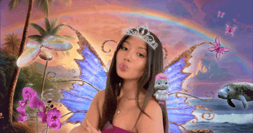 a girl wearing a tiara and fairy wings blows a kiss