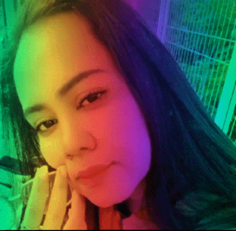 a close up of a woman 's face with a rainbow of colors