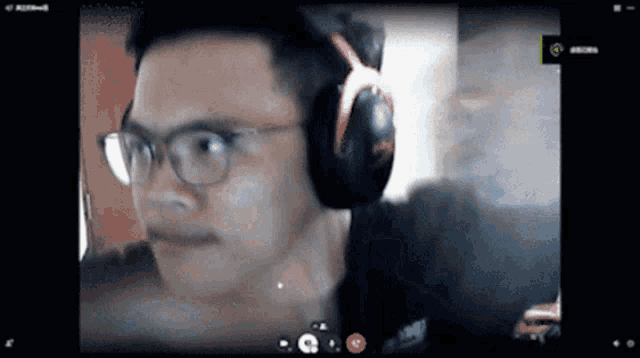 a man wearing glasses and headphones is looking at the camera