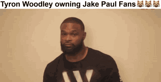 tyron woodley owning jake paul fans is written above a picture of a man