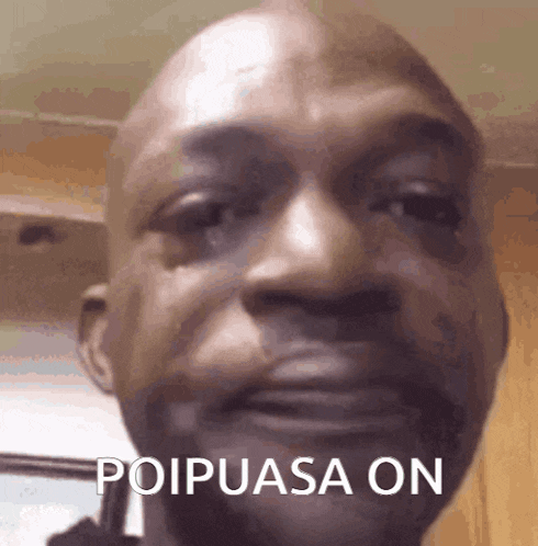 a close up of a man 's face with the words poipusa on written on it